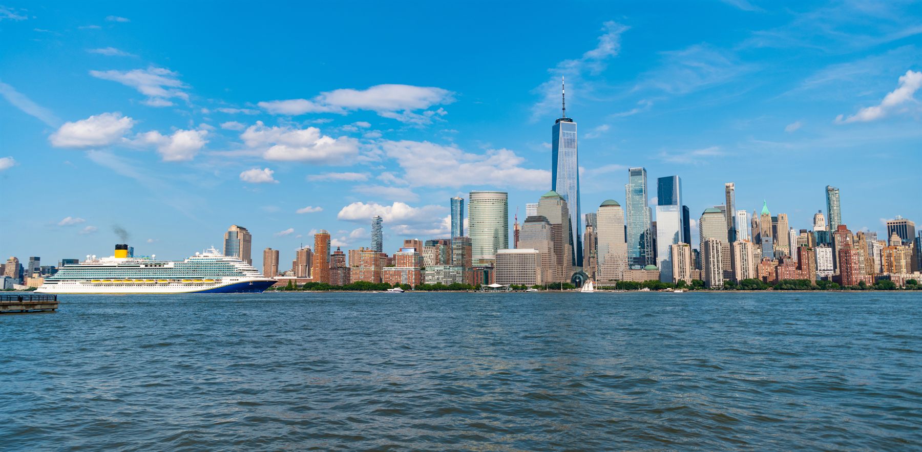 A cruise ship sailing past the Manhattan skyline in New York